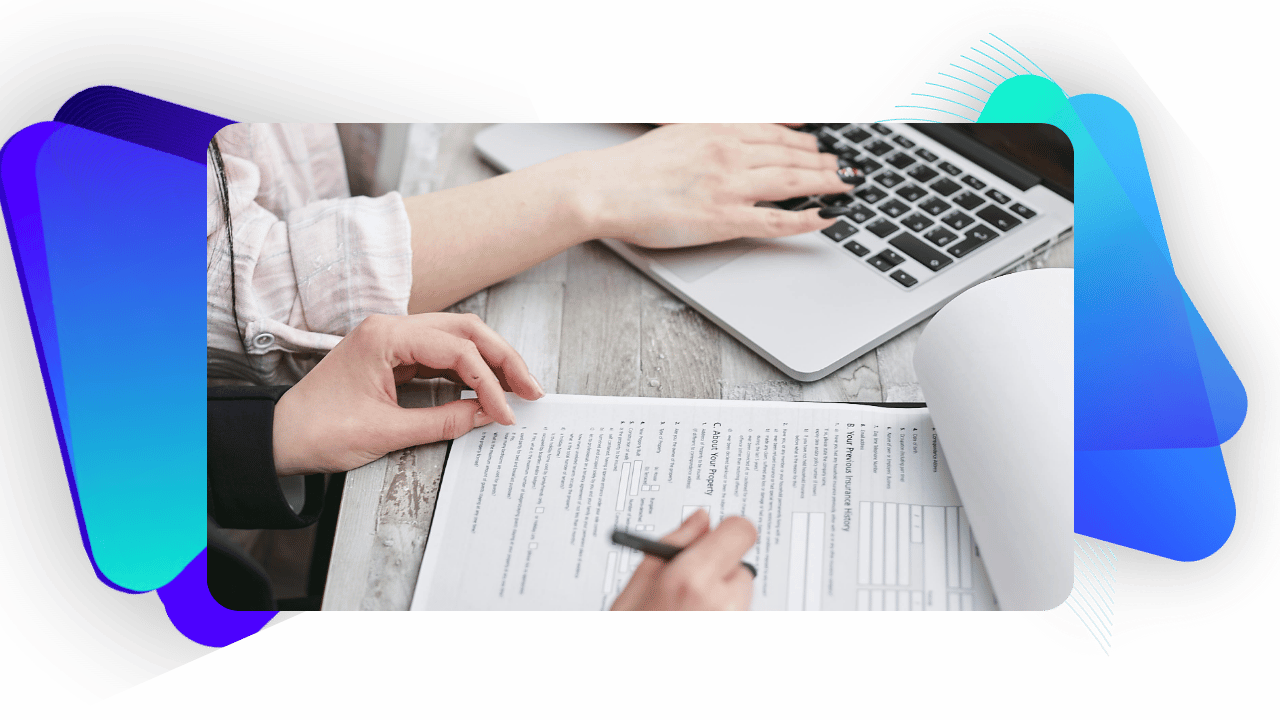 Two people's hands collaborating on loan documents.