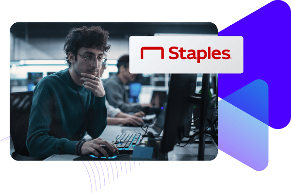 Staples with developer working on computer in office.