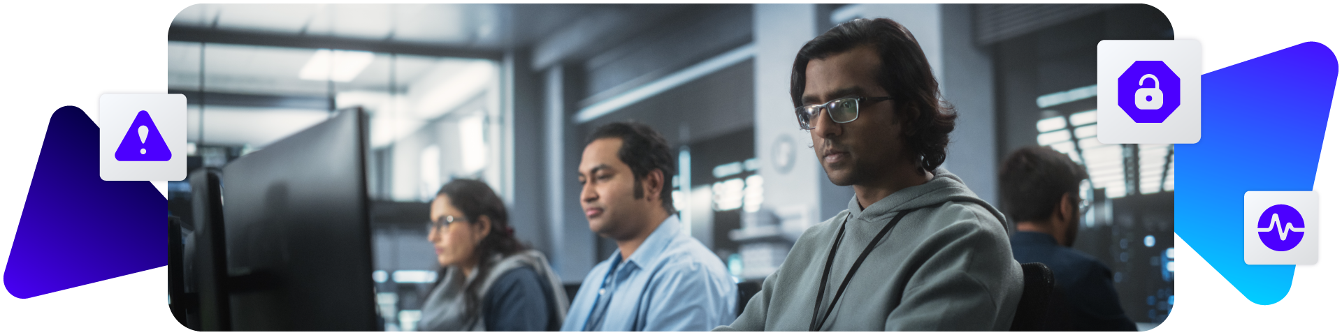 Developers working at computers in an office with warning icons.