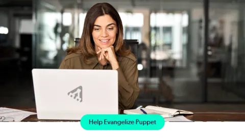 A young, working professional woman working on a laptop with a Puppet icon on the cover
