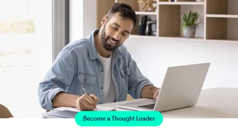 Man writing on laptop contributing to the Puppet thought leadership